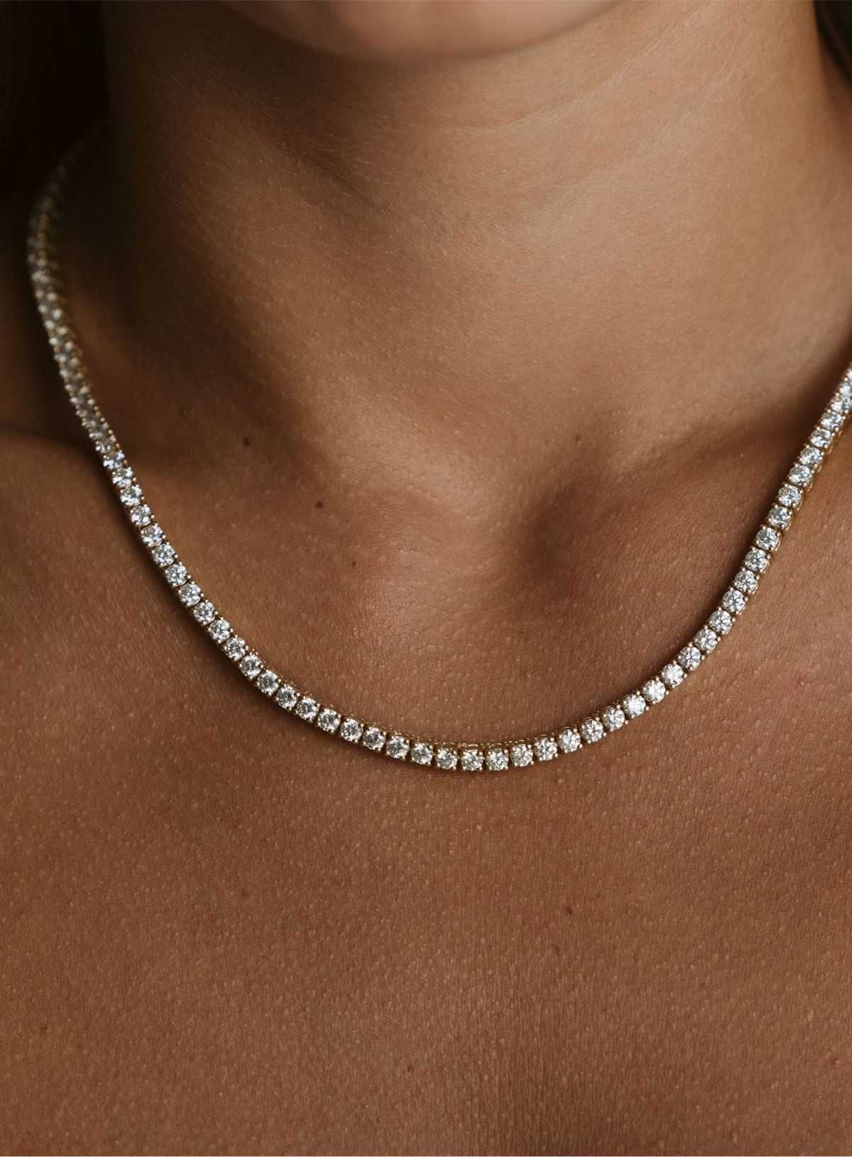 Close-up of a diamond necklace on a person's neck